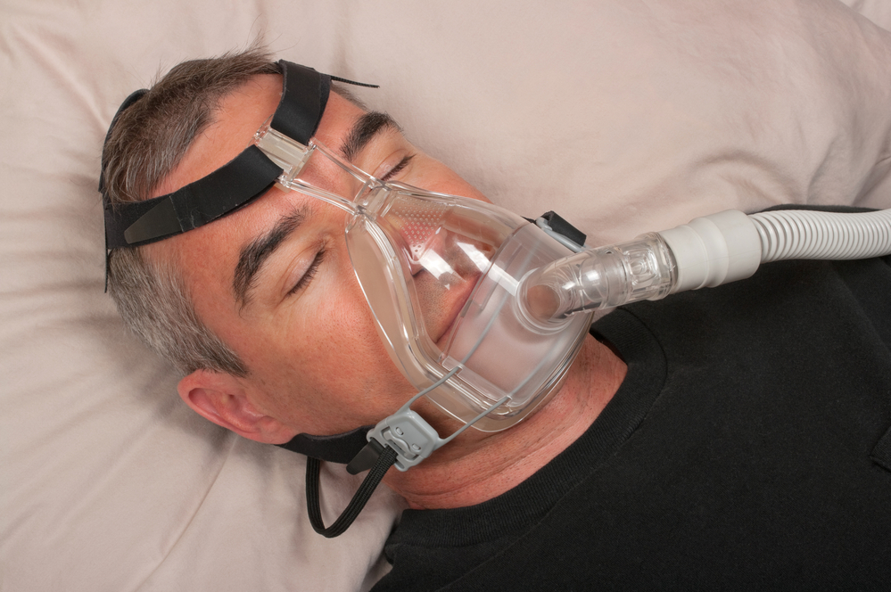 Man sleeping with CPAP mask on
