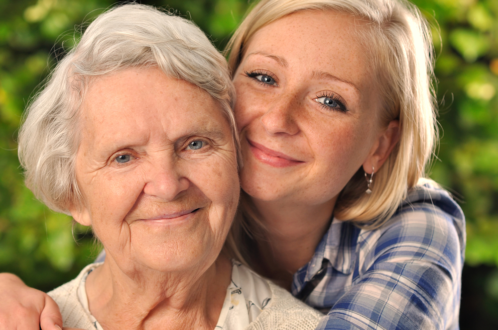 Young woman and elderly woman smiling