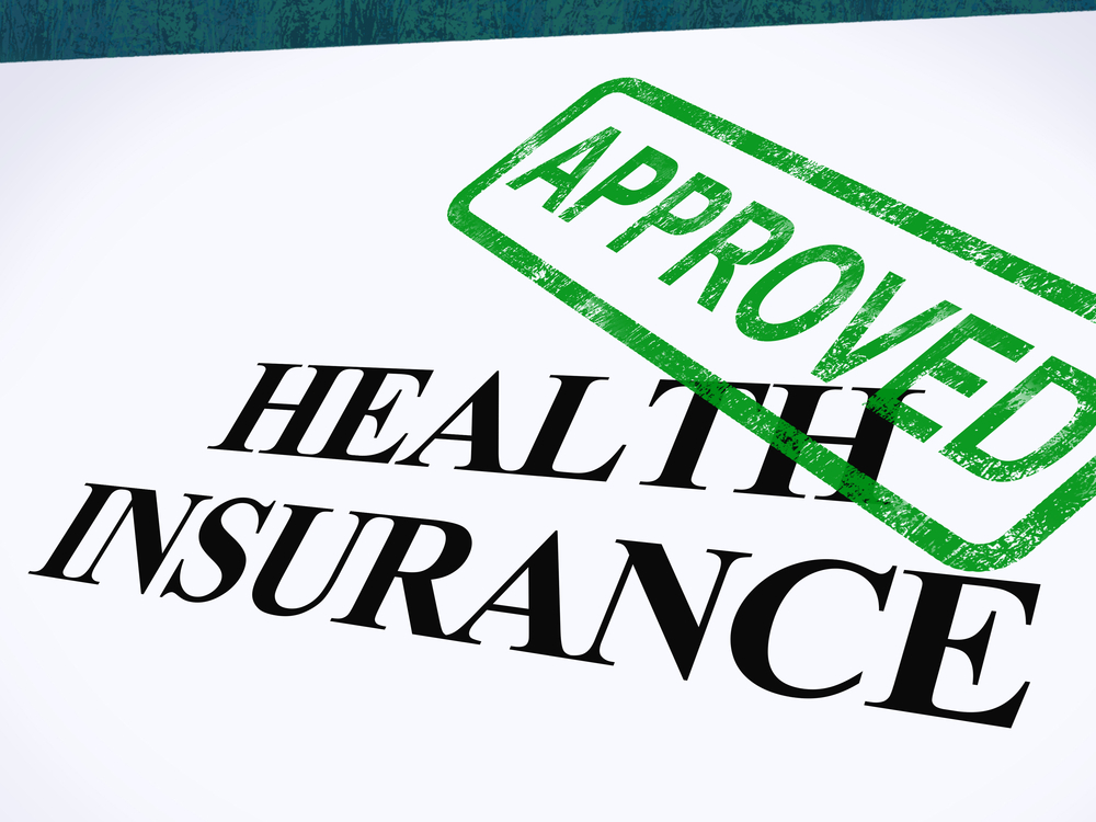 Health insurance form stamped with APPROVED in green