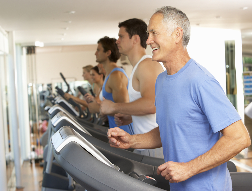 Senior man on treadmill at gym