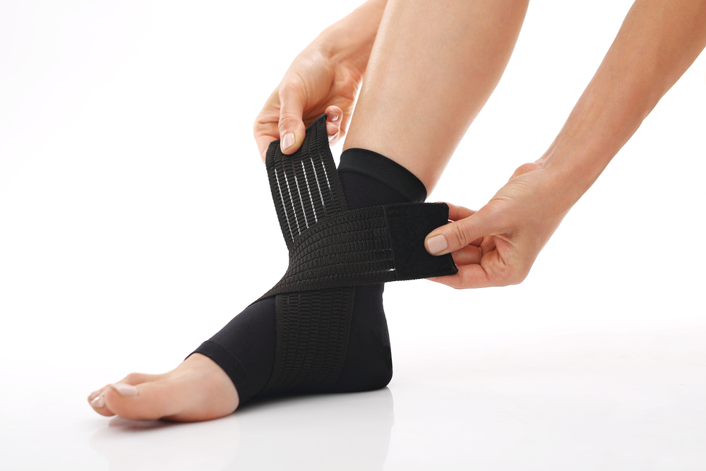 Woman putting on ankle brace