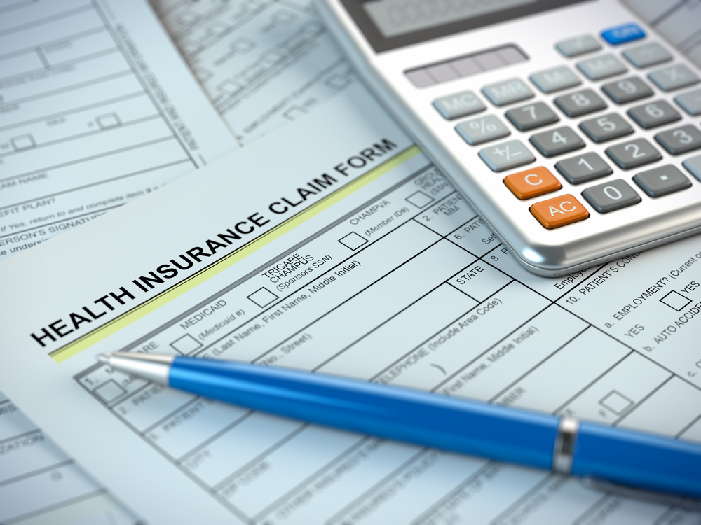 Insurance claim form with calculator and pen