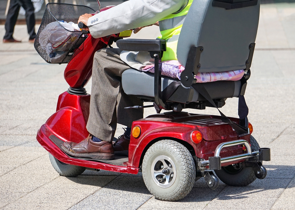 Close up of senior man on red mobility scooter